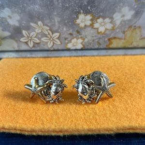 Two-toned, silver/gold tropical clip-on earrings.